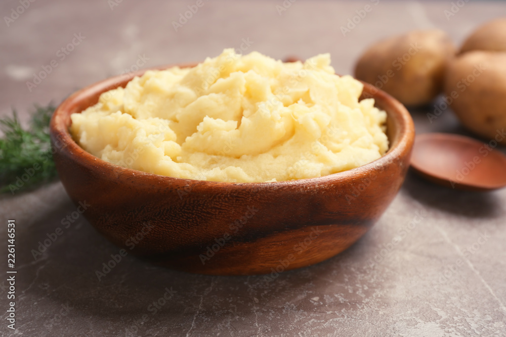 Bowl with mashed potatoes on grey table Bowl with mashed potatoes on grey table