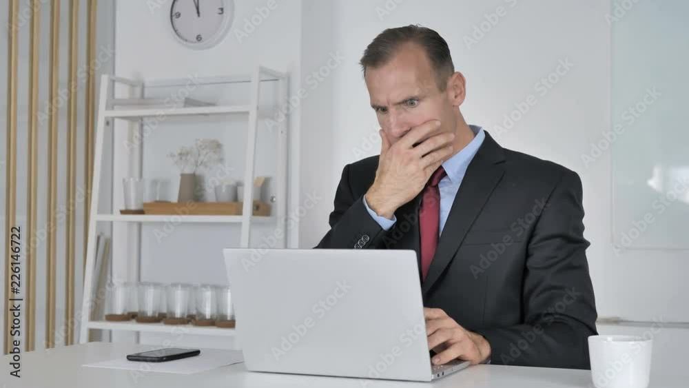 Shocked Middle Aged Businessman Working on Laptop, Astonished Shocked Middle Aged Businessman Working on Laptop, Astonished
