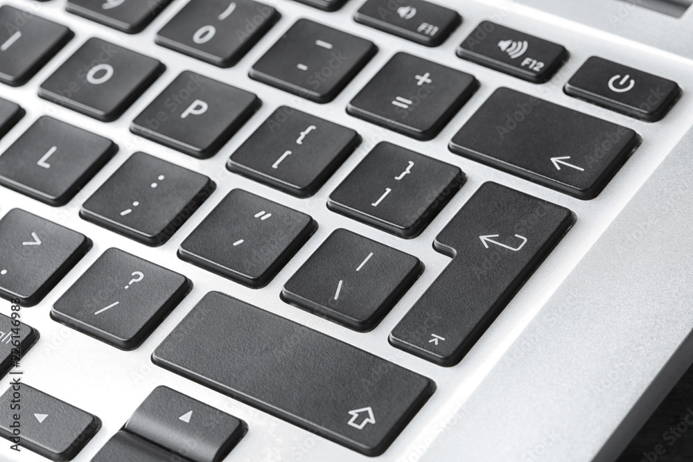 Modern laptop keyboard with black buttons, closeup view