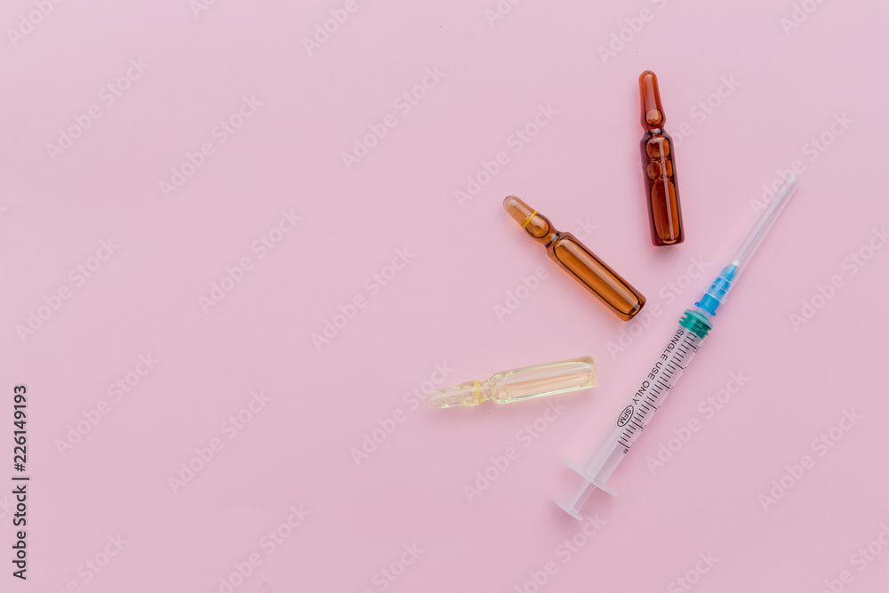 Beauty Injection, facial skin lifting on pink background concept.Glass Medicine Vials ampule ,medicine pill and capsule isolated. concept of cosmetic injections.Copy space Beauty Injection, facial skin lifting on pink background concept.Glass Medicine Vials ampule ,medicine pill and capsule isolated. concept of cosmetic injections.Copy space