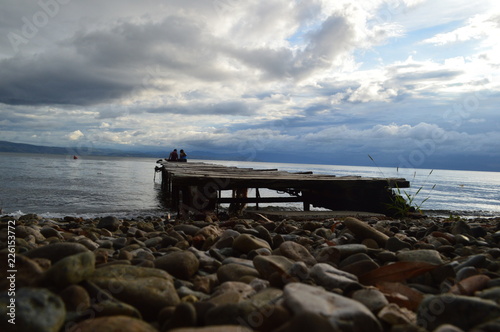 Landscape afternoon Beach with Jetty and Couple in Love