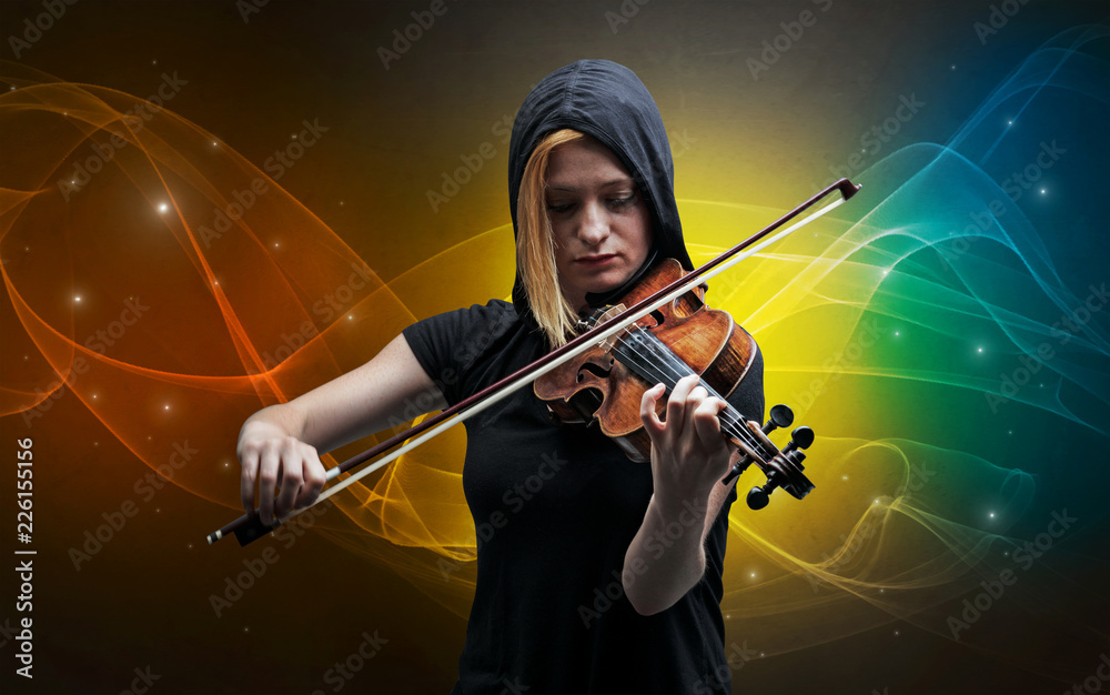 Fototapeta premium Serious classical violinist with fabled sparkling wallpaper