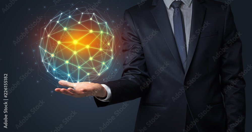 Businessman in suit holding global connection symbol on his hand Businessman in suit holding global connection symbol on his hand