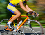 Racing bicycle in blurred motion speeding down the road.