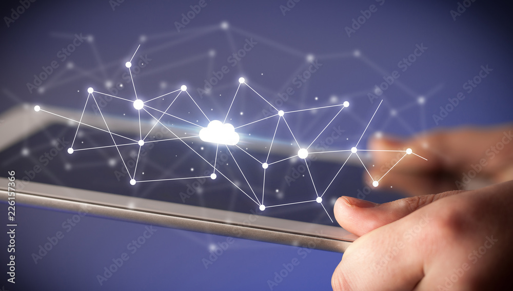 Female hands touching tablet with white cloud concept Female hands touching tablet with white cloud concept