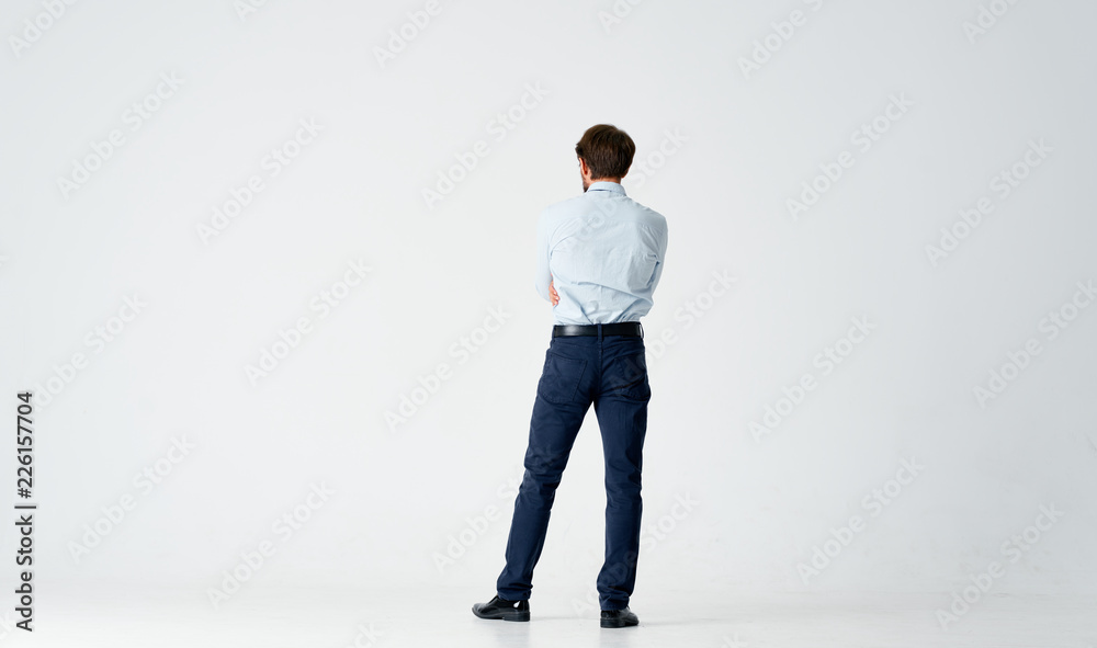 business man in shirt stands with his back to the camera on an isolated background business man in shirt stands with his back to the camera on an isolated background