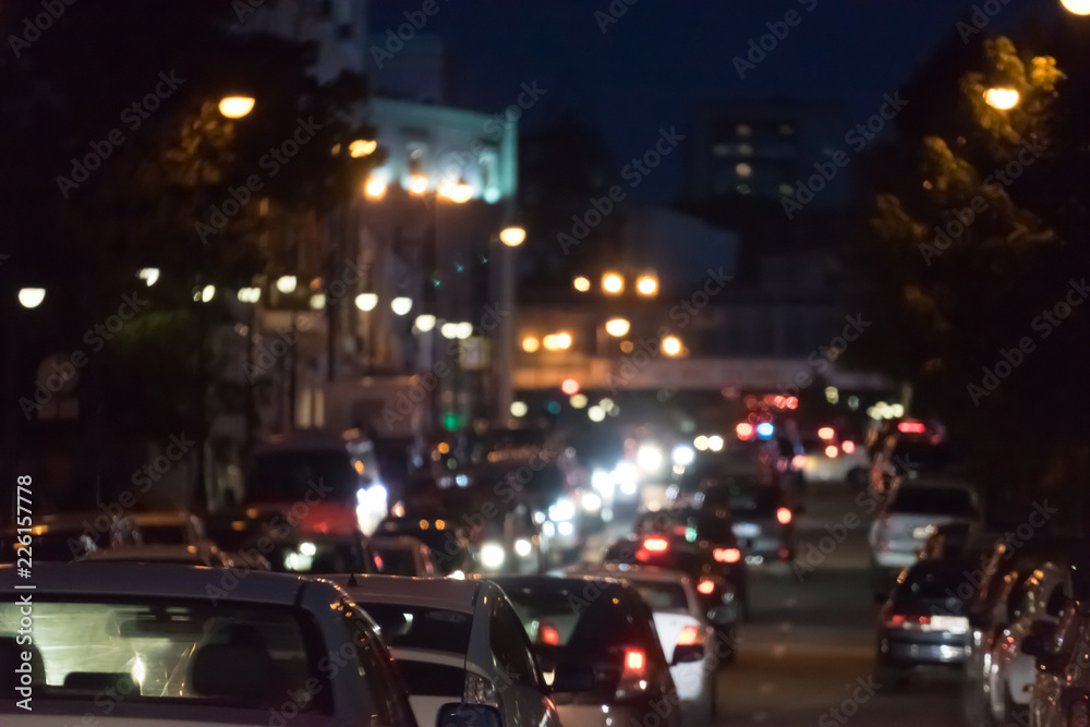 Urban landscape with a view of traffic jams at night. Lots of lights, traffic cars, background with blur.