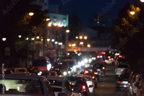 Urban landscape with a view of traffic jams at night. Lots of lights, traffic cars, background with blur.