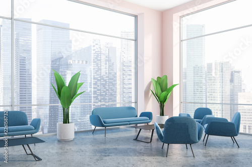 Pink wall office waiting area, blue sofas