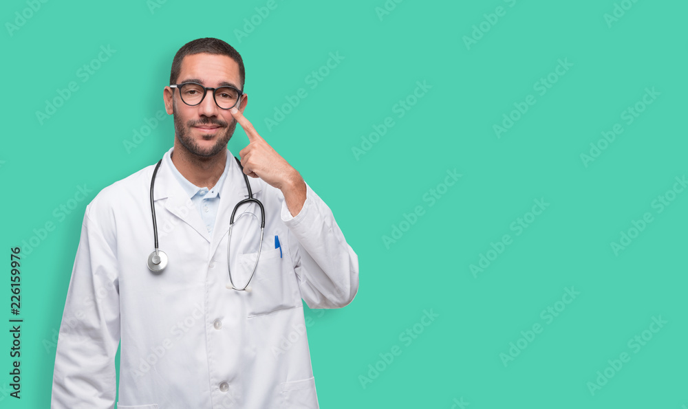 Doubtful young doctor with a gesture of observe Doubtful young doctor with a gesture of observe