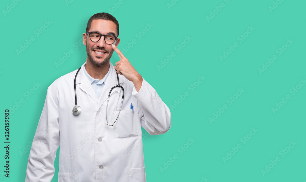 Happy young doctor doing a gesture of observe Happy young doctor doing a gesture of observe