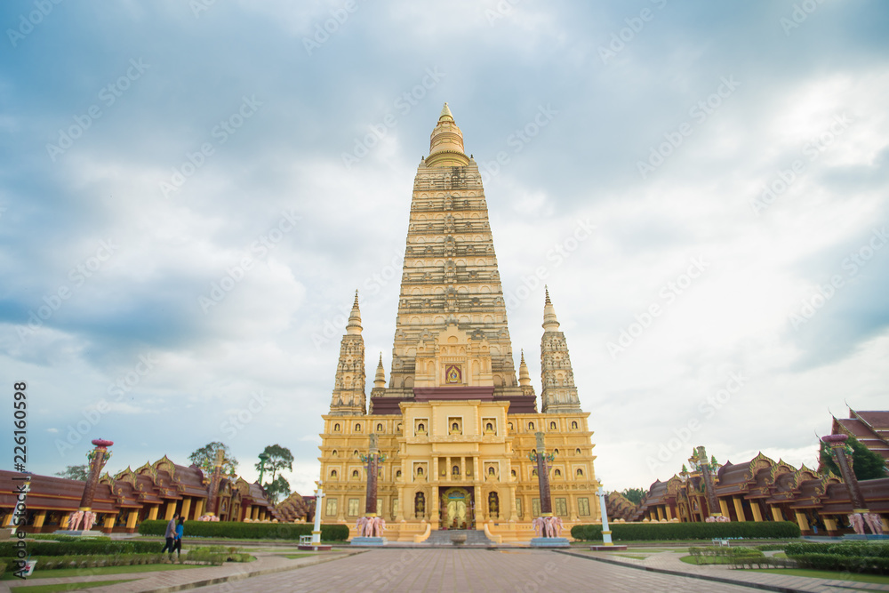 Fototapeta premium public golden giant huge pagoda big temple buddha statue in Krabi province , southern of Thailand with beautiful cloudy blue sky background