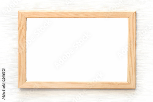 Blank light wooden frame for picture hanging on white wall. Realistic vector illustration