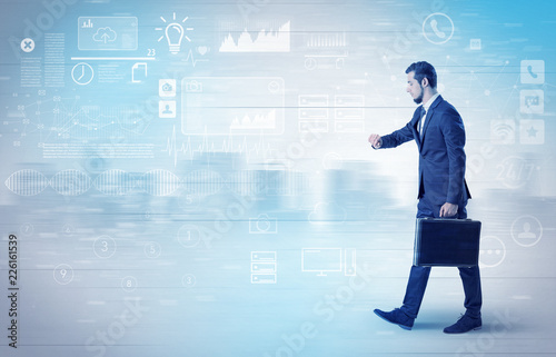 Handsome businessman walking in suit with briefcase on his hand and database concept around 