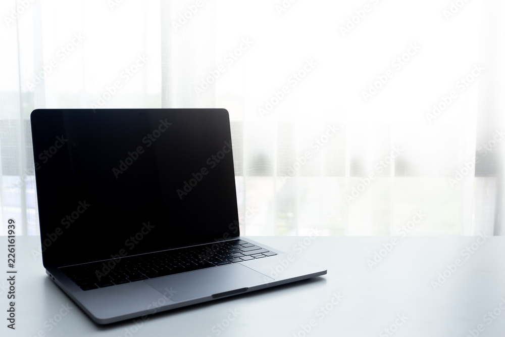 Workplace with laptop and soft light on white table Workplace with laptop and soft light on white table