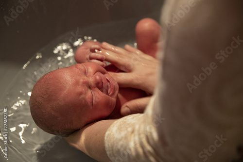 the newborn takes the first bath