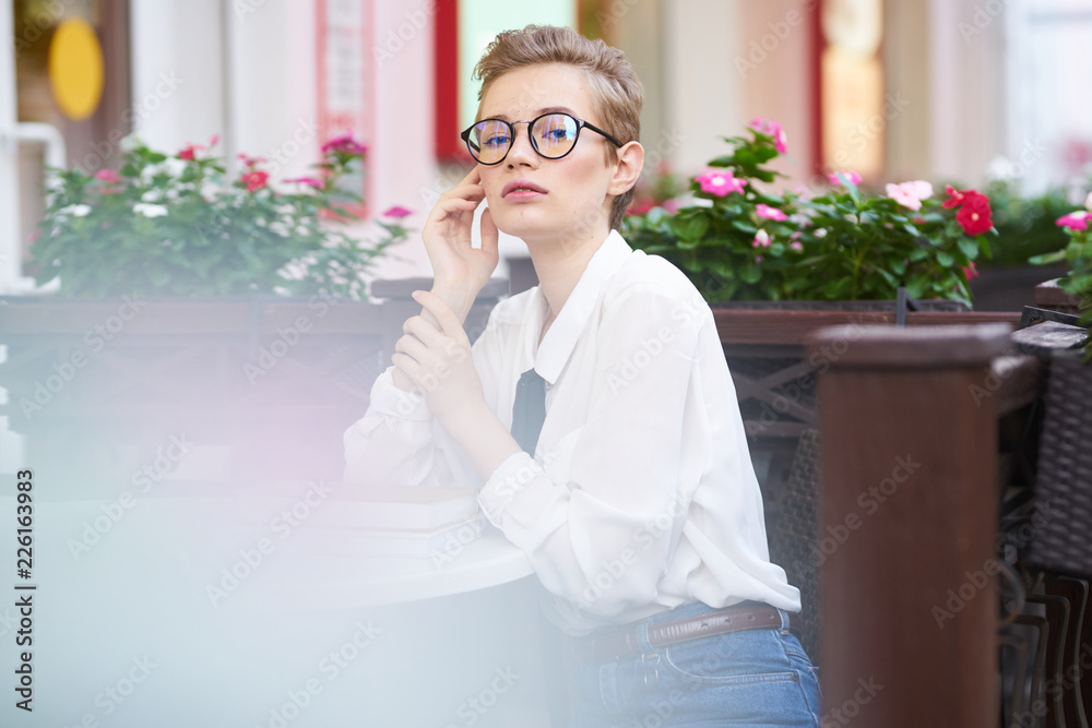beautiful business woman with glasses sitting in a cafe beautiful business woman with glasses sitting in a cafe