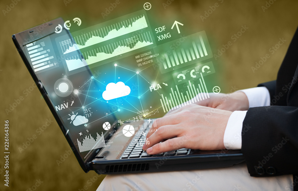Hand using laptop with cloud technology and linked information concept Hand using laptop with cloud technology and linked information concept
