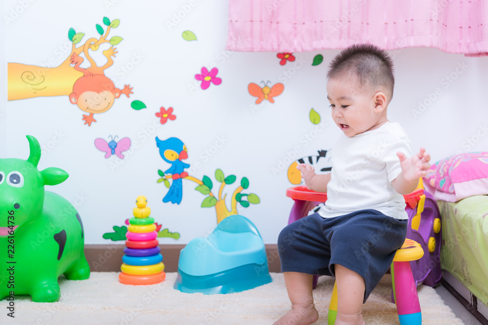 Fototapeta premium Asian portrait cute child boy and there are toys on back