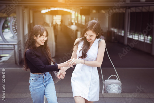 Portrait of two asian best friends smiling and feeling happy walking together in the city