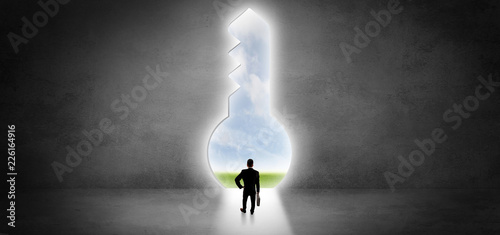 Businessman standing alone in front of a big keyhole
