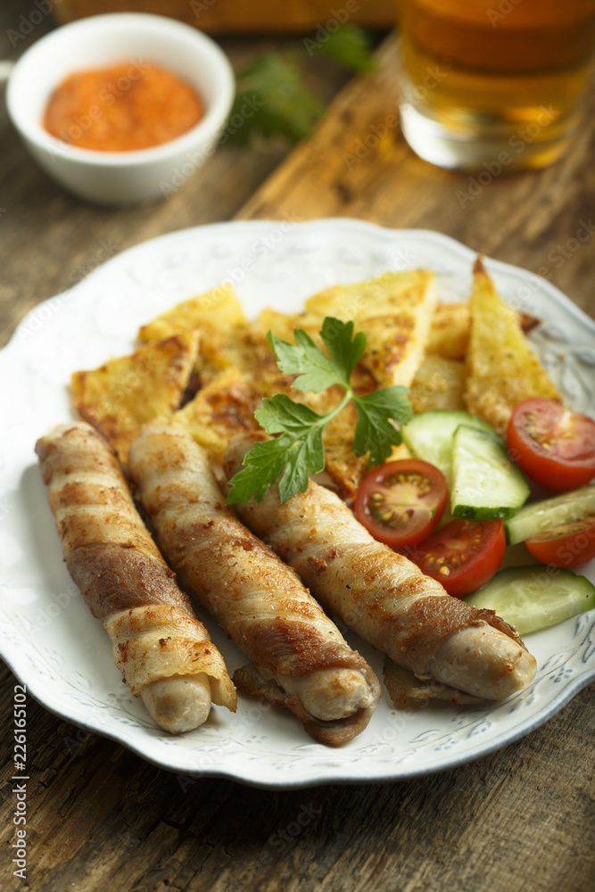Grilled sausages wrapped with bacon Grilled sausages wrapped with bacon