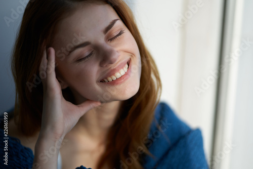happy woman with closed eyes smiling