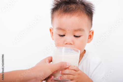 Asian portrait child boys 1 year 6 months drinking milk on glass