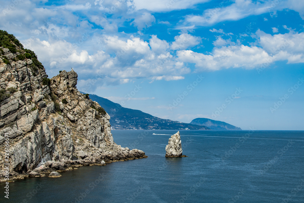 Coast of the Black Sea, Crimea. The view with the blue water and daylight sky with the boat on the horizon