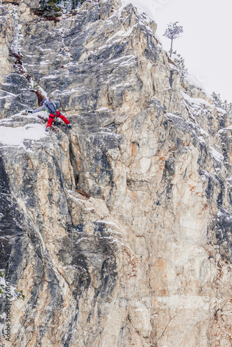 Off-piste skiers are practicing rock climbing.