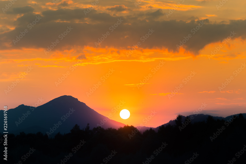 A beautiful, colorful sunset landscape with lake, mountain and forest. Natural evening scenery over the mountain lake in summer. Tatra mountains in Slovakia, Europe. A beautiful, colorful sunset landscape with lake, mountain and forest. Natural evening scenery over the mountain lake in summer. Tatra mountains in Slovakia, Europe.