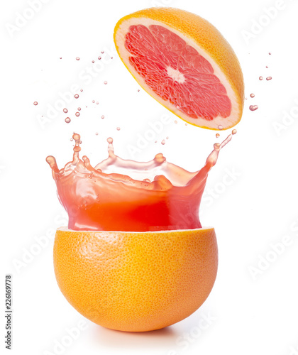 juice splashing out of a grapefruit isolated on white