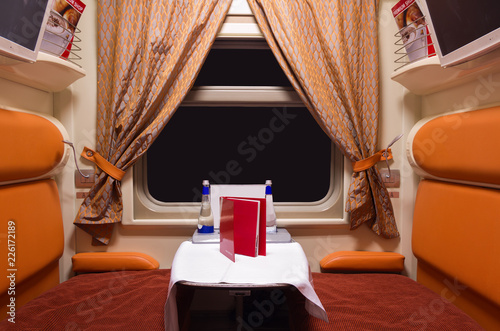 Railroad train luxury interior at night, black window