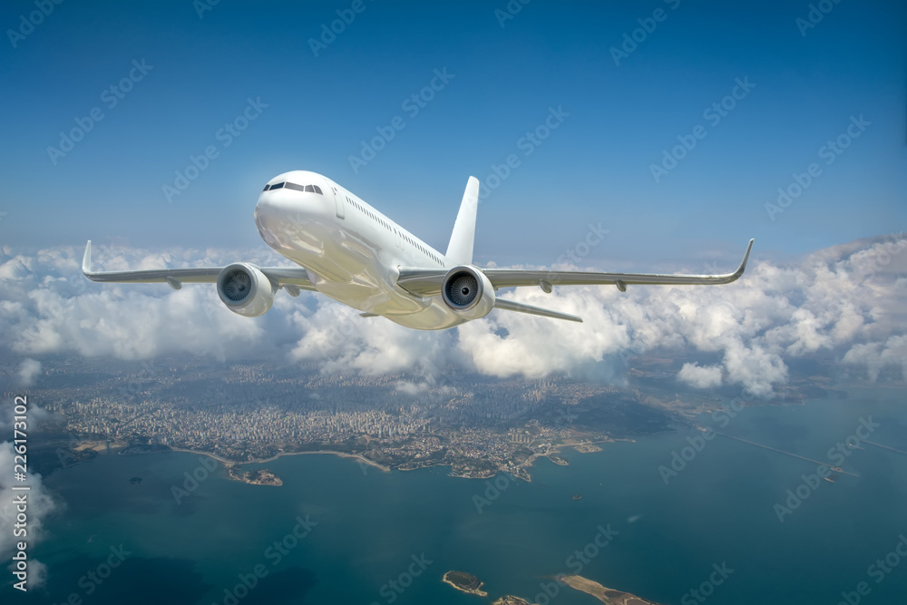 Obraz premium Passenger airplane in the clouds. passenger plane flying over the city