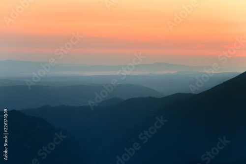 A beautiful, colorful, abstract mountain scenery in sunrise. Minimalist landscape of mountains in morning in blue tones. Tatra mounains in Slovakia, Europe. © dachux21