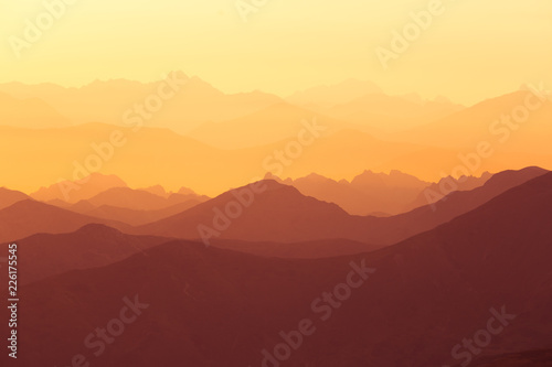 A beautiful, colorful sunrise sceney in mountains in purlpe tone. Abstract, minimalist landscape in Tatra mountains. Color gradients. Tatra mountains in Slovakia, Europe.