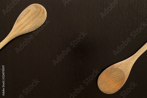 Wooden spoons on black table