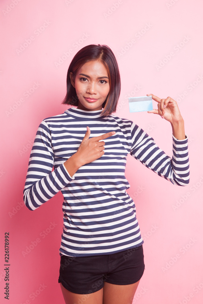 Young Asian woman point to a blank card. Young Asian woman point to a blank card.