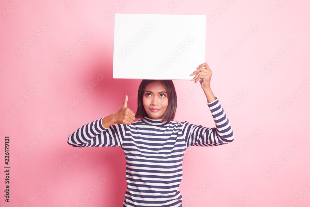Young Asian woman show thumbs up with white blank sign. Young Asian woman show thumbs up with white blank sign.
