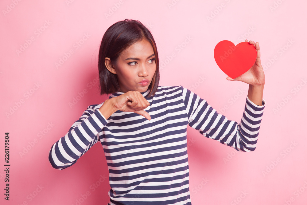 Asian woman thumbs down with red heart. Asian woman thumbs down with red heart.