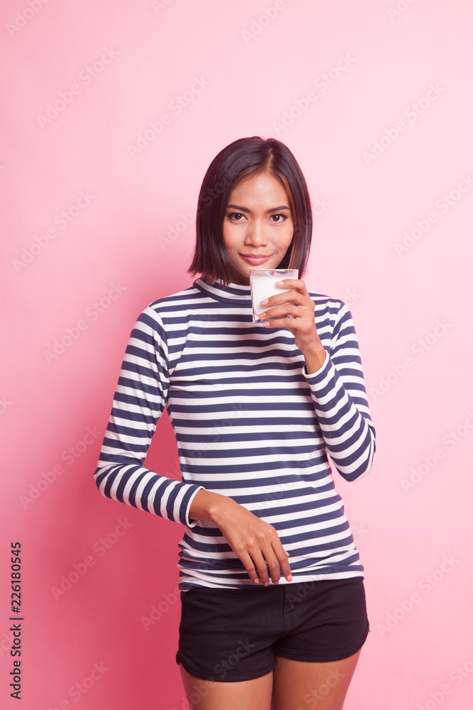 Healthy Asian woman drinking a glass of milk. Healthy Asian woman drinking a glass of milk.