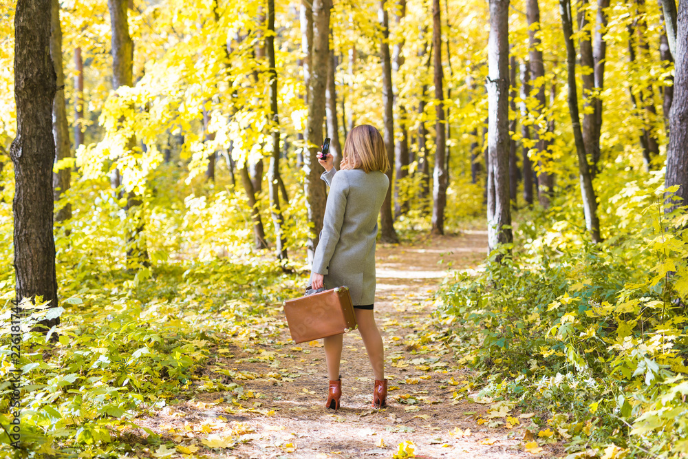 Season, technology and people concept - beautiful young woman in autumn nature taking selfie with smartphone Season, technology and people concept - beautiful young woman in autumn nature taking selfie with smartphone