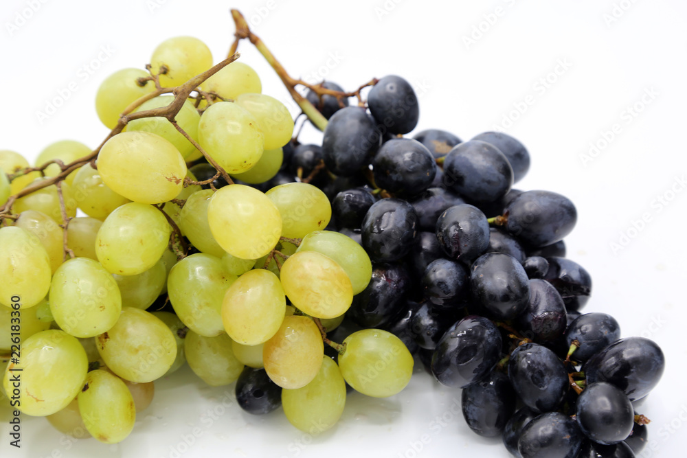 White and black grapes. Grapes isolated on white. White and black grapes. Grapes isolated on white.