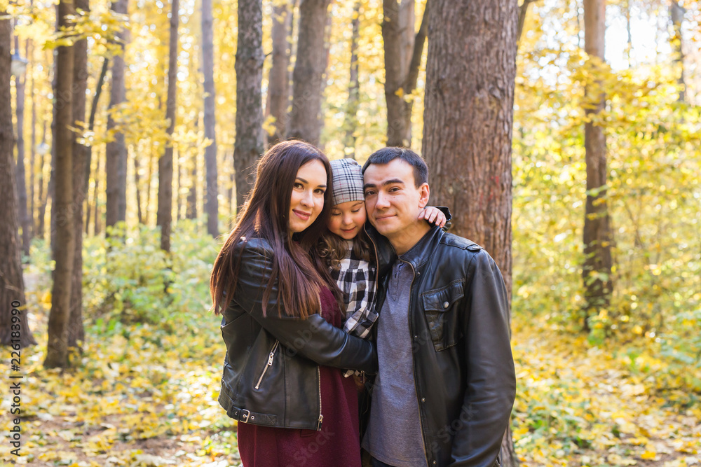 Children, nature and family concept - Portrait of happy family over autumn park background Children, nature and family concept - Portrait of happy family over autumn park background