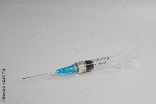 Syringe with anabolic steroids on a white background
