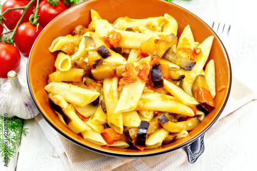 Pasta penne with eggplant and tomatoes on kitchen towel