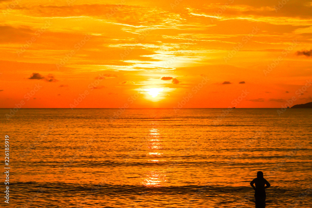 view of orange sea sunrise and silhouette single people in thailand