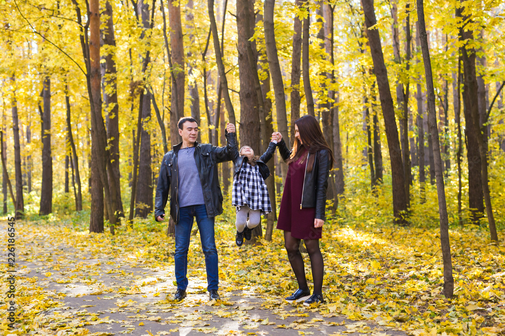 Fototapeta premium Parenthood, fall and people concept - young family happy in autumn park