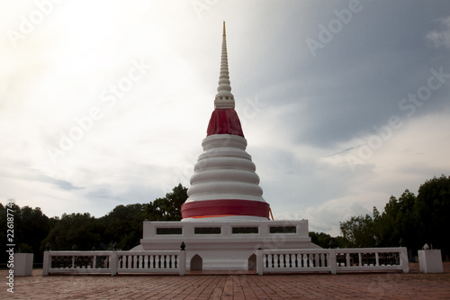 Archaeological site of Phra Chedi Klang Nam evening sky and dark tree for background at Rayong Thailand.