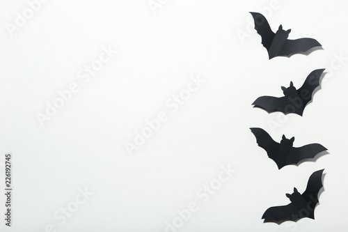 Halloween paper bats on white background